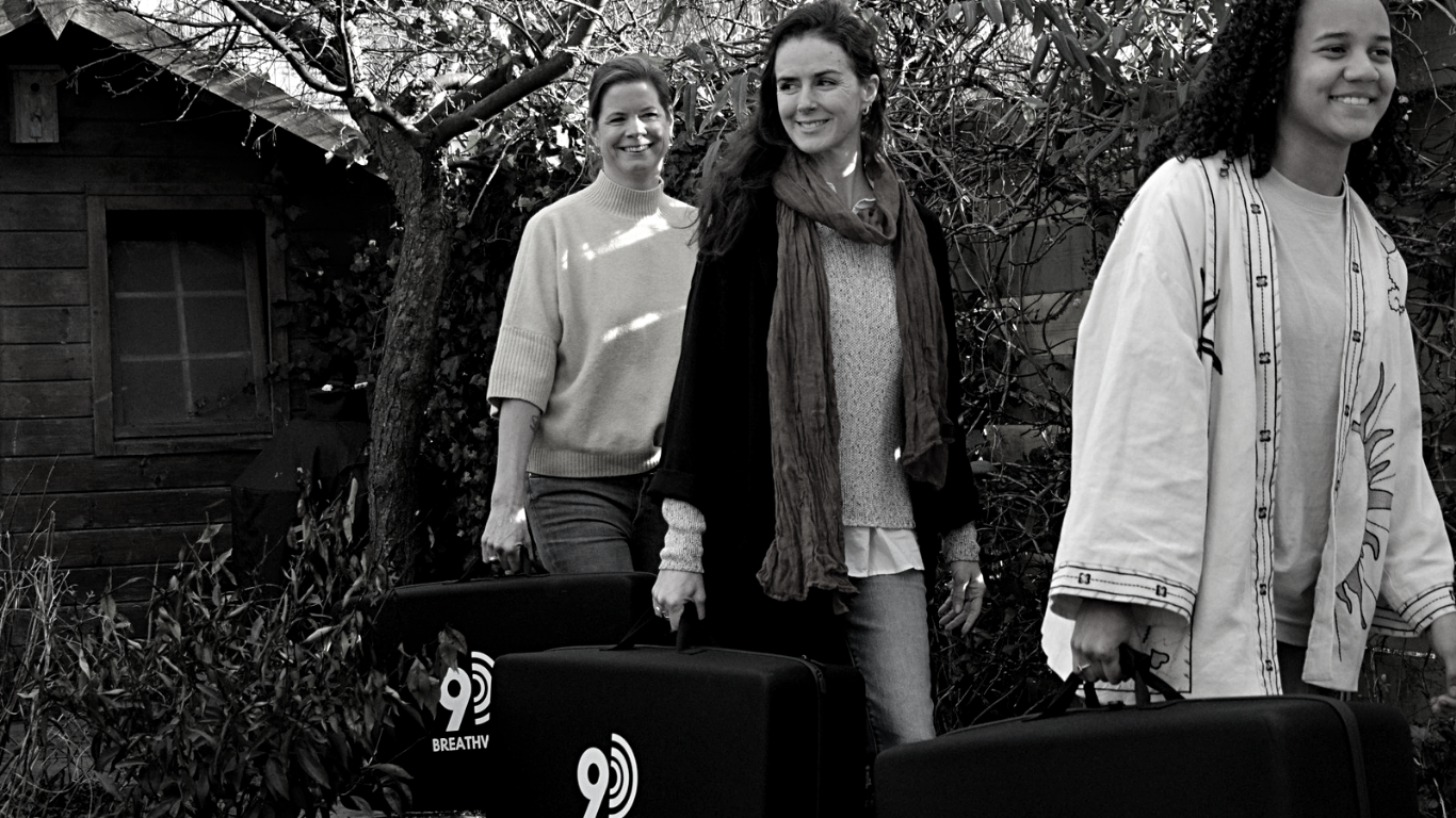 Dany Fenton and her team carrying 9D breathwork speakers, ready to lead a corporate wellbeing workshop