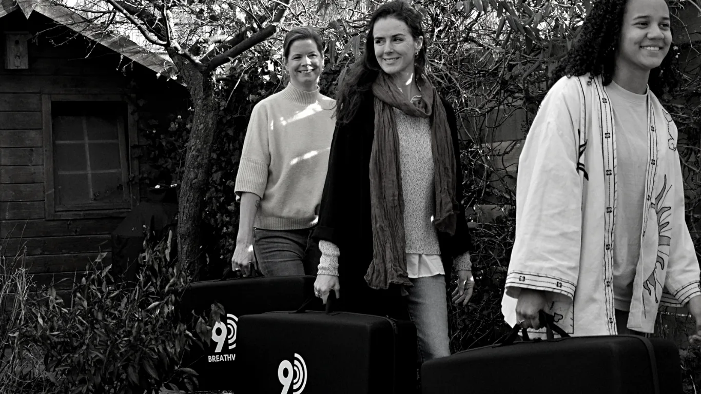 Dany Fenton and her team carrying 9D breathwork speakers, ready to lead a corporate wellbeing workshop