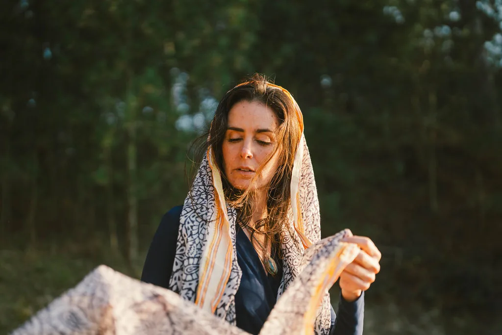 Dany Fenton in intimate close-up, patterned shawl draped over her head, eyes softly closed – representing the deep personal attention of a 1:1 session