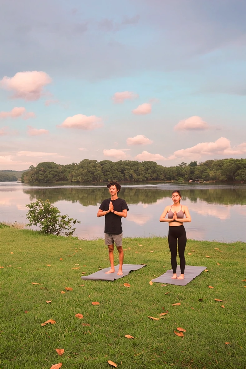 Group yoga session with members on mats outdoors during a seasonal reset day retreat at The Reconnected Land